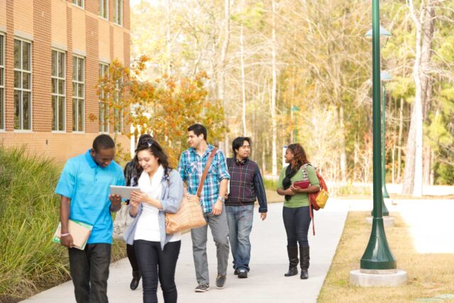 photo - College Students Talking and Walking on Campus