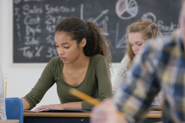 photo - High School Student in Classroom Taking a Test