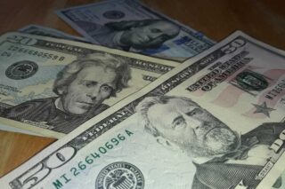 photo - money scattered on table