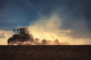photo - Farmer in Tractor Preparing Land with Seedbed Cultivator