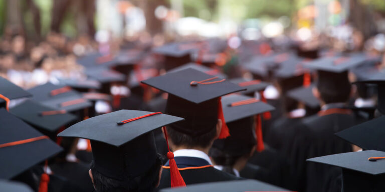 photo - Backside of Graduation Hats During Commencement Ceremony