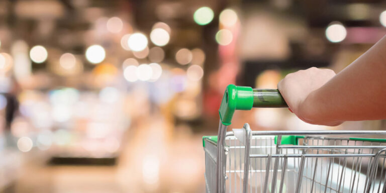 photo - Grocery cart being pushed through the store