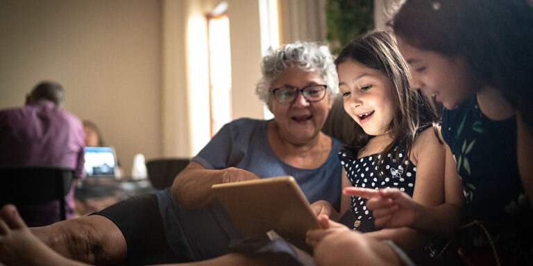 photo - Grandmother and Granddaughter on a Video Call with a Digital Tablet