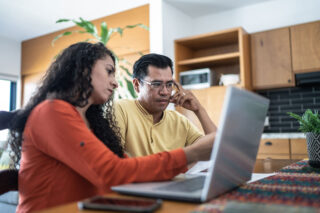 photo - Couple Working on Taxes at Home