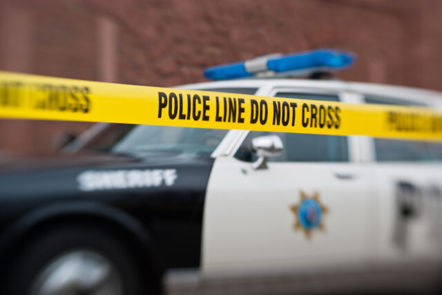 photo - police car with yellow barrier tape