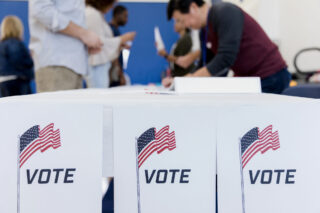 photo - voting posters with people registering to vote