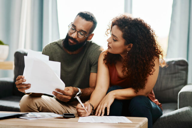 photo - Couple Working on Financial Paperwork Together at Home