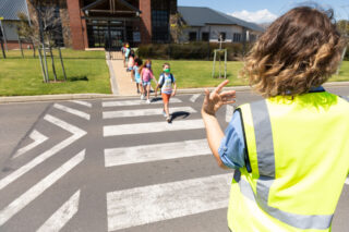 photo - Group of Kids Wearing Face Masks Crossing the Road