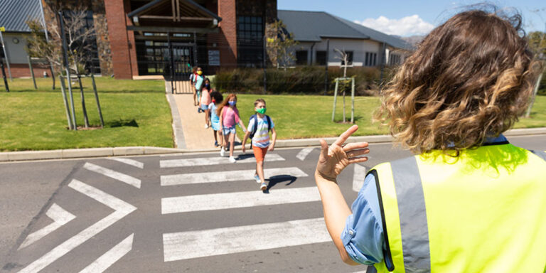 photo - Group of Kids Wearing Face Masks Crossing the Road