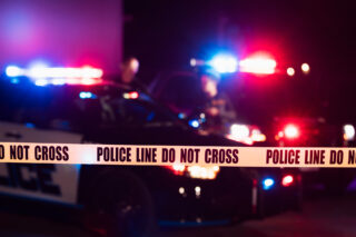 photo - Police cars responding to an incident with police line tape