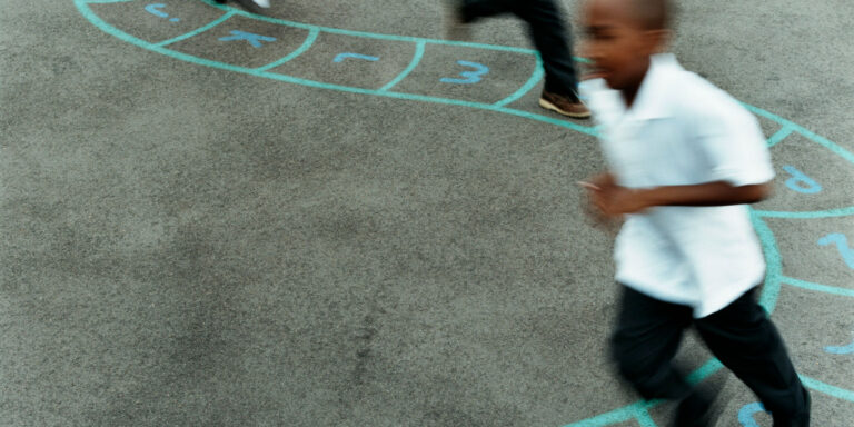 photo - Primary School Children Chasing Each Other in a School Playground
