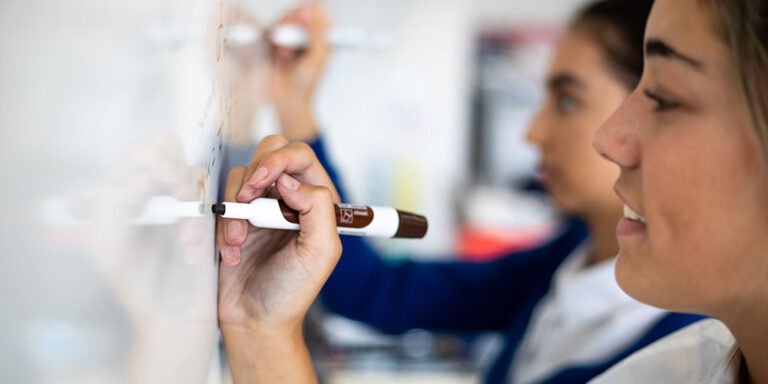 Teenage girls writing on a whiteboard pdf