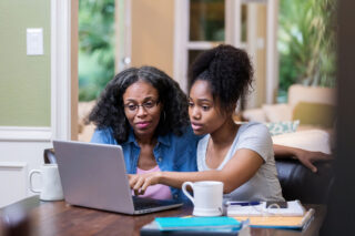 photo - Student with mom looking at laptop
