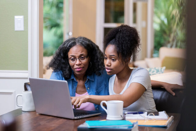 photo - Student with mom looking at laptop