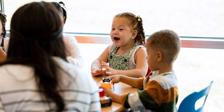 photo - Preschool age children interact with teacher pdf