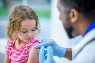 photo - Young Girl Receiving Flu Shot from Doctor