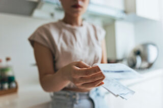 photo - Women Examining Shopping Receipt at Home
