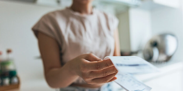 photo - Women Examining Shopping Receipt at Home