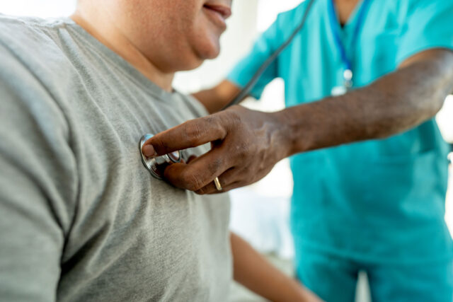 photo - Nurse Checks Heartbeat of Patient in Doctor's Office