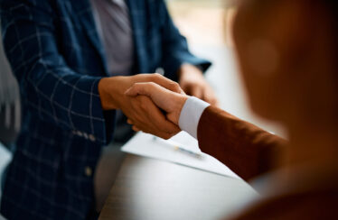 Close up of coworkers handshake
