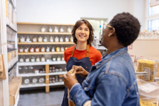 photo - Grocery Shop Owner Assisting a Female Customer