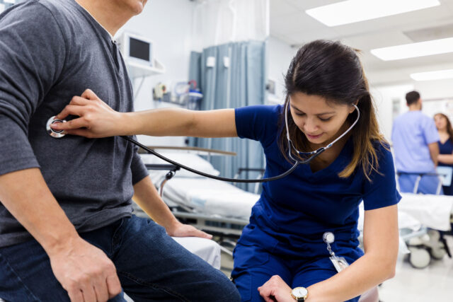 photo - Nurse Checks Heartbeat of patient in Emergency Room of Hospital