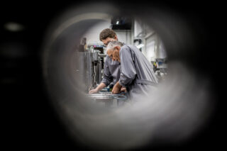 photo - Workers Operating Machinery in Factory