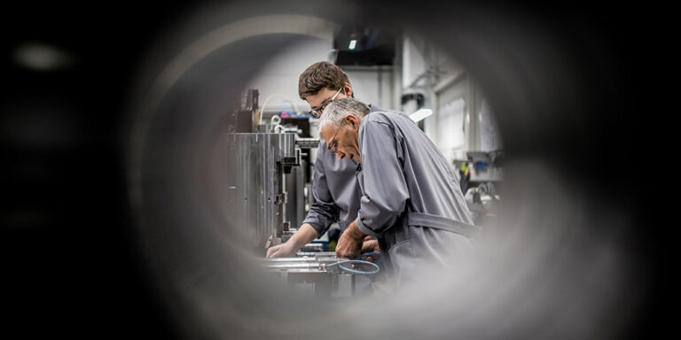 photo - Workers Operating Machinery in Factory