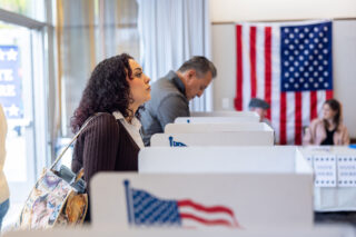 photo - Voter Looking Up from Ballot at Polling Station