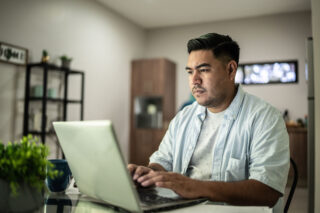 photo - Man Using Laptop at Home