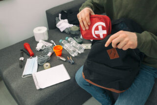 photo - Person Packing To Go Bag in Case of Disaster