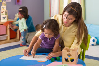 photo - Child Care Worker Drawing with Little Girl