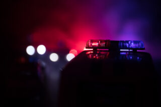 photo - Police Car Chasing a Car at Night