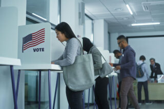 photo - Voters in Voting Booths with American Flag Logo at Polling Station