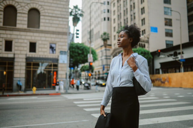 photo - Businesswoman Walking in Downtown Los Angeles