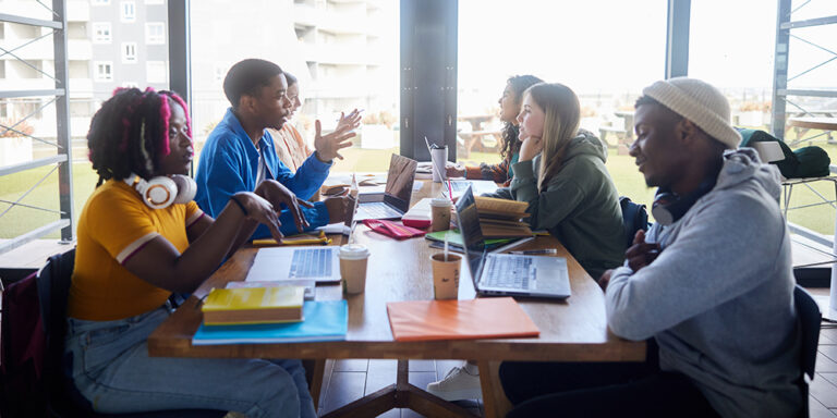 photo - College Students Studying around a Cafeteria Table