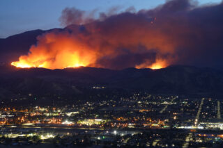photo - Wildfire in Hills above City in California at Night