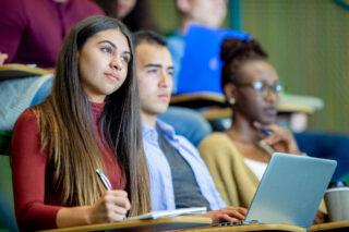 photo - Students watching lecture in university classroom