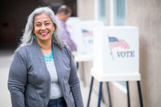 photo - Woman Looking at Camera and Smiling after Voting