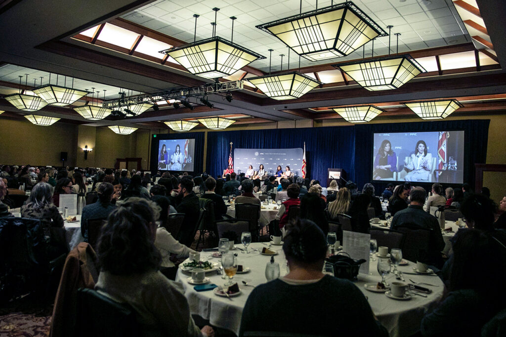 photo - The audience listens attentively to the speakers.
