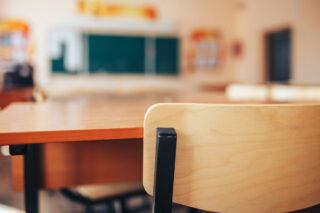 photo - Empty School Classroom with Closeup Shot of Desk