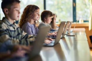 photo - Students using computers during class at elementary school