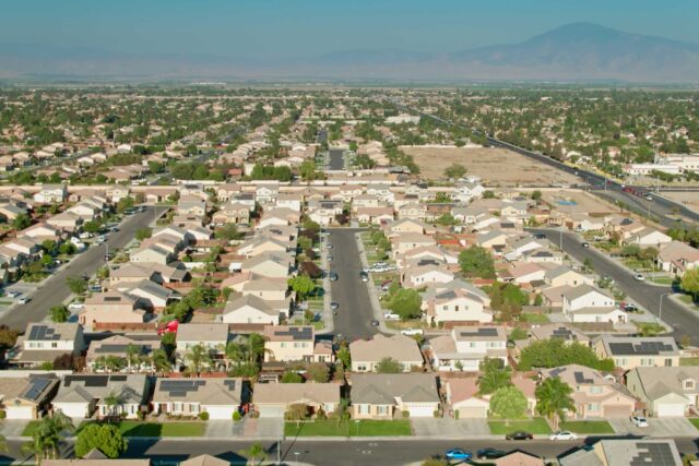 photo - Aerial View of Suburban Residential Streets in Bakersfield, California with Mountains in Background