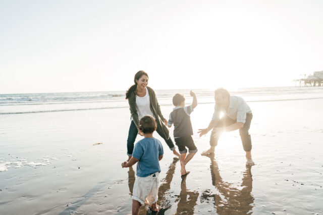 photo - Parents Playing with Kids on the Beach