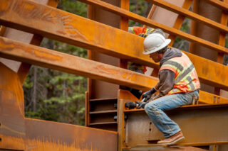 photo - Steel Workers Putting Fasteners on Bridge across Rubicon Creek in El Dorado National Forest, California