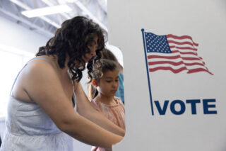 photo - Mother with her Daughter Voting at Polling Booth