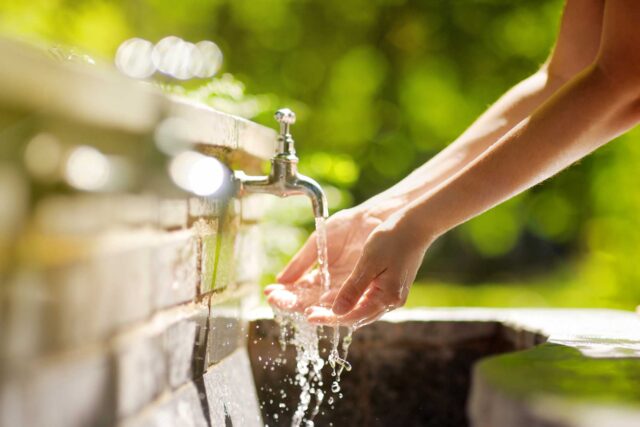 photo - Woman Washing Hands under Faucet
