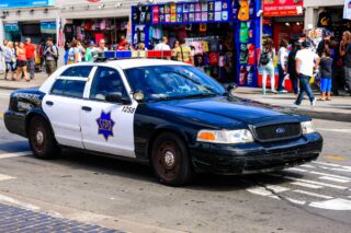 photo - Police Car Driving Down Jefferson Street in San Francisco