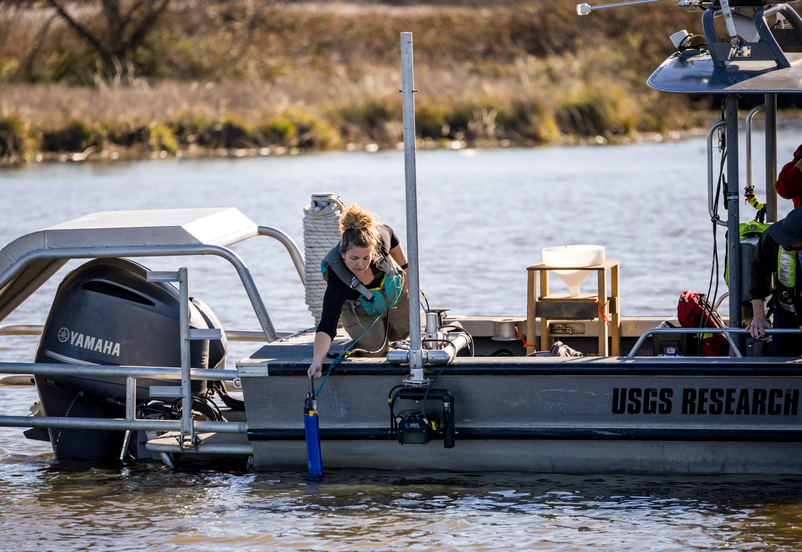 photo - Senior Environmental Scientist Trishelle Tempel, with California Department of Water Resources’ Division of Integrated Science and Engineering, performs research from a United States Geological Survey boat after a release of Delta smelt from the Lookout Slough boat ramp in Solano County, California