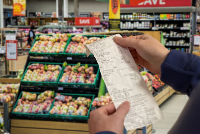 photo - Woman Holding Receipt at Grocery Store